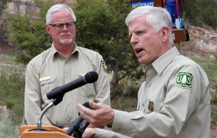 U.S. Forest Service Southwest Regional Forester Corbin Newman, left, listens as Forest Service Chief Tom Tidwell talks about the national fire outlook during a news conference at the Sandia Ranger Station in Tijeras, N.M. on Thursday.